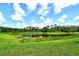 Beautiful view of the lush grounds with pond on this property at 2469 Paradise Plum Dr, Sarasota, FL 34240