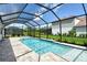 Enjoy this beautiful screened-in pool with an attached spa and well manicured landscaping at 2469 Paradise Plum Dr, Sarasota, FL 34240