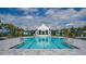 Resort style community pool featuring a building with arches and outdoor umbrellas at 2469 Paradise Plum Dr, Sarasota, FL 34240
