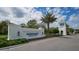 Community entrance sign for Windward Lakewood Ranch with blue lettering and mature palm trees at 2469 Paradise Plum Dr, Sarasota, FL 34240