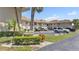 A condominium complex with mature landscaping and ample parking on a sunny day at 2727 75Th W St # 1Af, Bradenton, FL 34209