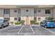 Condominium building exterior featuring a central entrance with assigned parking and maintained landscaping at 2727 75Th W St # 1Af, Bradenton, FL 34209
