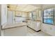 Open kitchen featuring white appliances, a tiled backsplash, and a bright window overlooking the exterior at 2727 75Th W St # 1Af, Bradenton, FL 34209