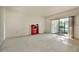 A well-lit living room featuring neutral carpet flooring and access to an outdoor patio at 2727 75Th W St # 1Af, Bradenton, FL 34209