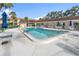 Community pool with lounge chairs and tables under bright umbrellas at 2727 75Th W St # 1Af, Bradenton, FL 34209