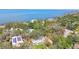 Aerial view of property showcasing lush landscaping, mature trees, and waterfront views at 3001 Bay Shore Cir, Sarasota, FL 34234