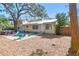 The backyard featuring a patio with hot tub, firepit, and blue Adirondack chairs at 3001 Bay Shore Cir, Sarasota, FL 34234