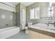Bathroom with stylish tile floor and walls, a tub, and a toilet at 3001 Bay Shore Cir, Sarasota, FL 34234