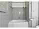Features a gray-tile surround with a shower-over-tub configuration at 3001 Bay Shore Cir, Sarasota, FL 34234
