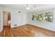 Bright bedroom with hardwood floors, ceiling fan, and large window at 3001 Bay Shore Cir, Sarasota, FL 34234