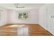 Sunny bedroom with hardwood floors, a window with natural light, and a closet to the right at 3001 Bay Shore Cir, Sarasota, FL 34234