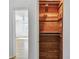 Wood closet with hanging rod and shelving for optimal storage at 3001 Bay Shore Cir, Sarasota, FL 34234