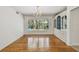 Charming dining room boasts a large window with views to the outside and built-in display cabinets for storage at 3001 Bay Shore Cir, Sarasota, FL 34234