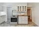 Kitchen featuring white cabinets, stainless steel oven, and ample counter space with an adjacent view to a storage area at 3001 Bay Shore Cir, Sarasota, FL 34234