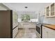 Bright white kitchen with updated appliances and countertops at 3001 Bay Shore Cir, Sarasota, FL 34234
