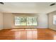 Inviting living room with polished hardwood floors, a large window, and neutral paint at 3001 Bay Shore Cir, Sarasota, FL 34234