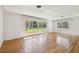 Bright living room with hardwood floors and large windows overlooking the landscaped yard at 3001 Bay Shore Cir, Sarasota, FL 34234