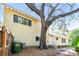 Sunlit side view of home, showcasing a neat yard, ample windows, and beautiful oak tree at 3001 Bay Shore Cir, Sarasota, FL 34234
