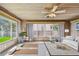 Cozy sun room features wood-paneled walls, plenty of natural light, and neutral furniture at 3001 Bay Shore Cir, Sarasota, FL 34234