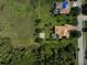 Aerial view showcasing a home with a pool, basketball court, and lush greenery, offering a serene lifestyle at 306 Country Meadows Way, Bradenton, FL 34212