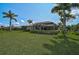 Expansive backyard with a basketball court, screened-in pool, and verdant lawn, creating a private retreat at 306 Country Meadows Way, Bradenton, FL 34212