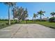 Well-maintained basketball court in a spacious backyard with mature trees, providing ample space for recreation at 306 Country Meadows Way, Bradenton, FL 34212