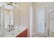 Modern bathroom with a stylish vanity, sink, and a glass-enclosed shower at 306 Country Meadows Way, Bradenton, FL 34212