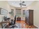 Functional home office with hardwood floors, natural light, and essential office equipment for productivity at 306 Country Meadows Way, Bradenton, FL 34212