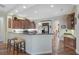 Spacious kitchen with stainless steel appliances and breakfast bar with stools at 306 Country Meadows Way, Bradenton, FL 34212