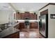 Gourmet kitchen with stainless steel appliances and beautiful wood flooring at 306 Country Meadows Way, Bradenton, FL 34212
