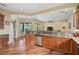 Open kitchen with stainless steel appliances and breakfast bar at 306 Country Meadows Way, Bradenton, FL 34212