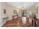 Bright living room featuring hardwood floors, neutral walls, and sliding glass doors leading to the pool area at 306 Country Meadows Way, Bradenton, FL 34212