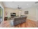 Open living room with hardwood floors, ceiling fan, and neutral walls at 306 Country Meadows Way, Bradenton, FL 34212