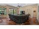 Living room with hardwood floors opens to screened in patio and backyard at 306 Country Meadows Way, Bradenton, FL 34212