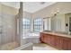 Luxurious bathroom featuring a soaking tub, walk-in shower, and a double vanity with granite countertop at 306 Country Meadows Way, Bradenton, FL 34212