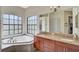 Elegant bathroom featuring a large soaking tub, double vanity, and separate walk-in shower at 306 Country Meadows Way, Bradenton, FL 34212