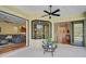 Covered patio with view of kitchen and access to the pool area at 306 Country Meadows Way, Bradenton, FL 34212