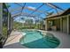Enjoy the screened-in pool with a clear blue sky and golf course views, perfect for relaxation and entertaining at 306 Country Meadows Way, Bradenton, FL 34212