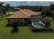 Aerial view of screened in pool and well-manicured backyard at 306 Country Meadows Way, Bradenton, FL 34212