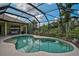 The screened-in pool provides a private oasis with a seating area, perfect for unwinding by the tranquil water at 306 Country Meadows Way, Bradenton, FL 34212