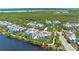 Aerial view of charming two-story homes nestled by waterways, in a community with tropical landscaping at 315 Sapphire Lake Dr # 101, Bradenton, FL 34209