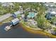 Aerial view of a luxurious waterfront community showcasing a pool, boat house, firepit, and beautifully landscaped grounds at 315 Sapphire Lake Dr # 101, Bradenton, FL 34209