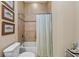 Closeup of a bathroom featuring a shower-tub combo with fish artwork on the wall at 315 Sapphire Lake Dr # 101, Bradenton, FL 34209