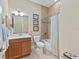 Bathroom with a vanity, toilet, and tiled shower-tub combo with a striped curtain at 315 Sapphire Lake Dr # 101, Bradenton, FL 34209