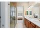 Bright bathroom featuring dual sinks, walk-in shower, and an open view to the bedroom at 315 Sapphire Lake Dr # 101, Bradenton, FL 34209
