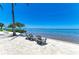 Beachside seating with lounge chairs facing the ocean, offering a peaceful retreat by the water at 315 Sapphire Lake Dr # 101, Bradenton, FL 34209