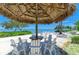 Tranquil beach setting featuring a covered table with chairs for outdoor relaxation at 315 Sapphire Lake Dr # 101, Bradenton, FL 34209