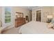 Bright bedroom features hardwood furniture and offers a view to the property through the window with shutters at 315 Sapphire Lake Dr # 101, Bradenton, FL 34209