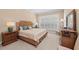 Cozy bedroom features a wicker bed frame, shutters, neutral colors, and coordinating furniture at 315 Sapphire Lake Dr # 101, Bradenton, FL 34209