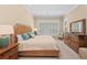 This bedroom is bathed in natural light and features neutral colors, shutters, and coordinating furniture at 315 Sapphire Lake Dr # 101, Bradenton, FL 34209